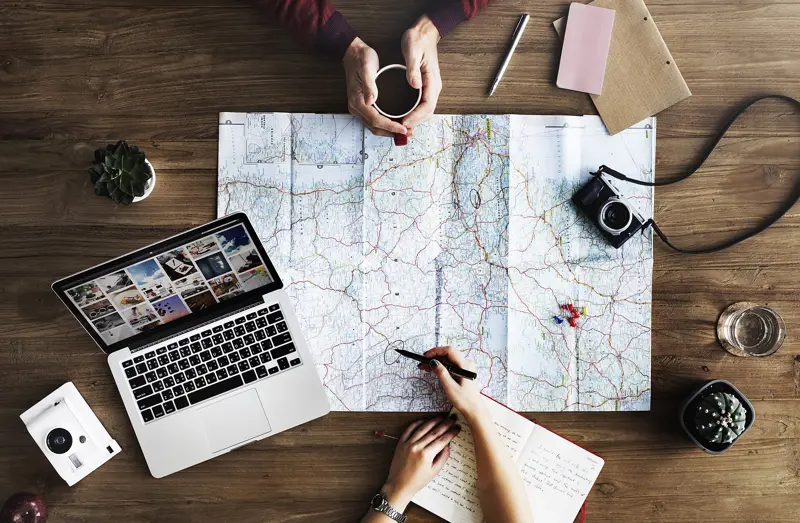 Planning a trip over coffee with a map and notes